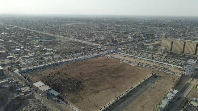 Drone footage from traditional Central Asian sport "Buzkashi" in which horse-mounted players attempt to place a goat or calf carcass in a goal, in Balkh, Afghanistan. March 21, ?2021