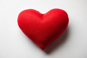 Fototapeta premium Minimalist Red Heart Pillow on White Background - Valentine's Day Stock Photo
