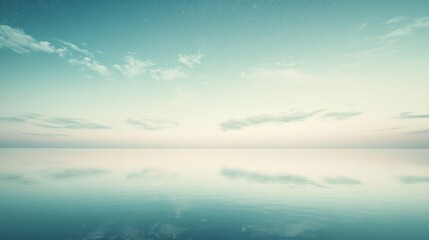 Obraz premium An ocean as calm as glass mirrors a sky dotted with soft clouds, blurring the boundaries between sky and sea in a tranquil symmetry.