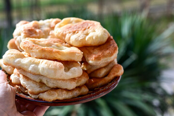 Traditional Bulgarian home made deep fried  patties  covered with sugar  оn rustic backgroud.Mekitsa or Mekica,  on wooden  rustic  background. Made of kneaded dough that is deep fried 