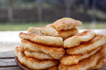 Traditional Bulgarian home made deep fried  patties  covered with sugar  оn rustic backgroud.Mekitsa or Mekica,  on wooden  rustic  background. Made of kneaded dough that is deep fried 