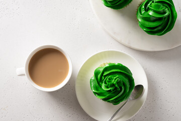 Patrick's Day homemade cupcakes with green whipped cream on white background. View from above. Copy space.