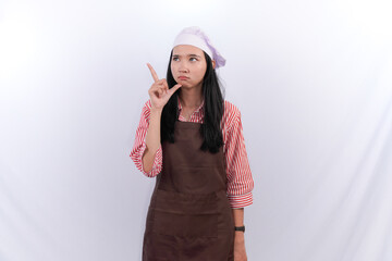 Naklejka premium Asian woman wearing chef's uniform thinking hard