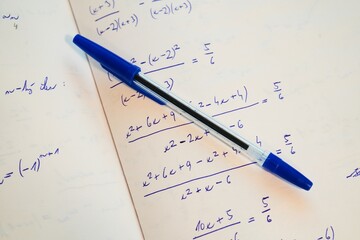 Mathematical Study Session – Notebook with Equations and Pen
