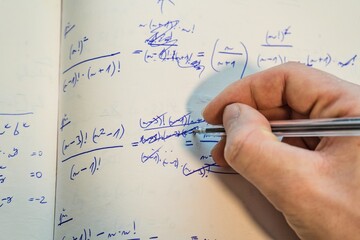 Solving Mathematical Equations – Handwriting in Notebook
