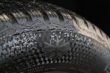 Close-Up of Winter Tire with Snowflake Symbol and Tread Pattern