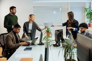 Group of employees working on a project in the office