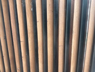 This image shows a close-up shot of the Akustik paneel, likely a type of acoustic wall paneling. The panels feature alternating strips of light and dark wood,