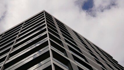 Fototapeta premium low angle of corner of contemporary residential building against cloudy sky