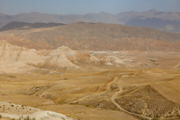 Arid Iranian landscape with unique geological formations and mountains