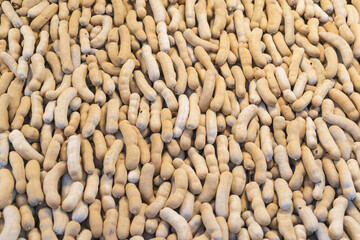 Close-Up of Fresh Brown Tamarind Pods in Bulk Display