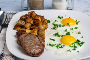 fried eggs top with parsley  with sausage patty
