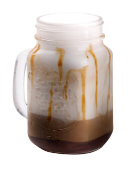 coffee mug with toffel and plenty of steamed milk and caramel sauce isolated