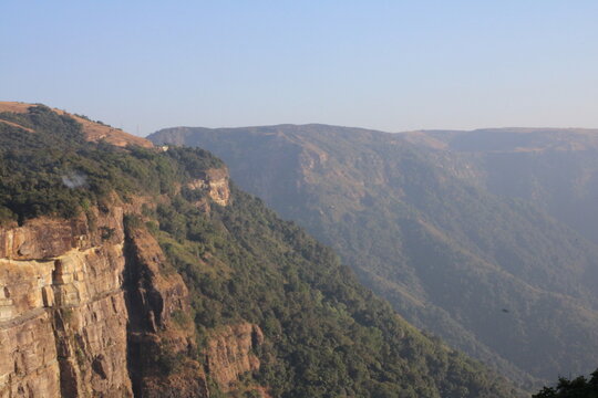 A stunning view of rockey mountain with a green landscape. 
