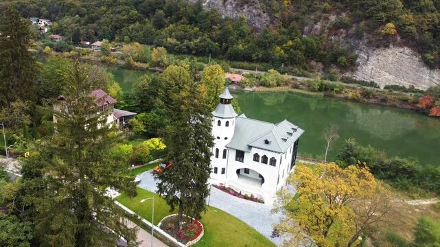 Drone view of the Calimanesti Multifunctional Center by the river surrounded by autumnal foliage