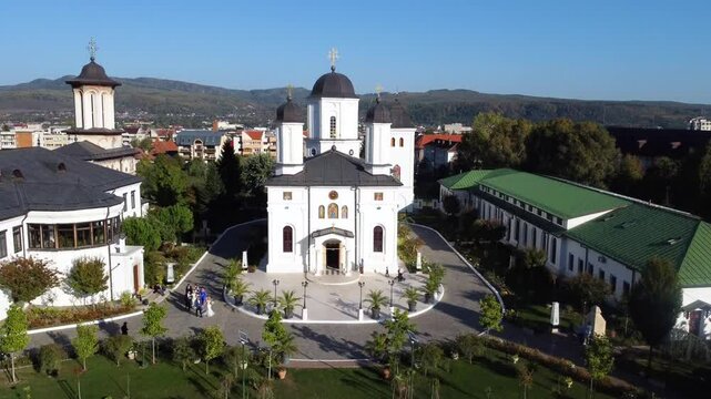 Aerial footage of a wedding ceremony outdoors of Archdiocese of Ramnic Monastery