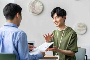 Obraz premium オフィスで打ち合わせをするスタッフ 撮影協力:スカパー東京メディアセンター