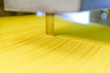 Modern factory for working with foam rubber. At initial stage of production, orange cube passes...