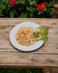 Fried rice served on a fruit plate on a wooden table with a garden background
