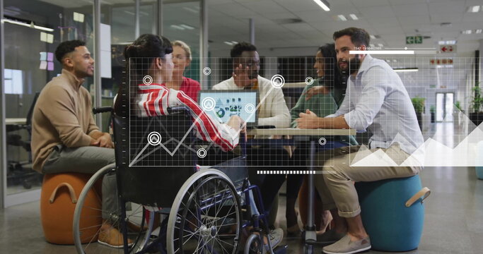 Image of diagrams over disabled and diverse colleagues discussing work in office