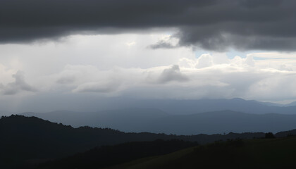 Fototapeta premium Landscape with rain and dramatic clouds over hills. With dark clouds covering the sky