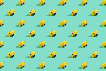 Yellow vintage film camera pattern on color pastel background.