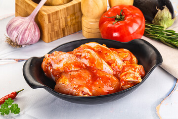 Raw marinated uncooked chicken wings