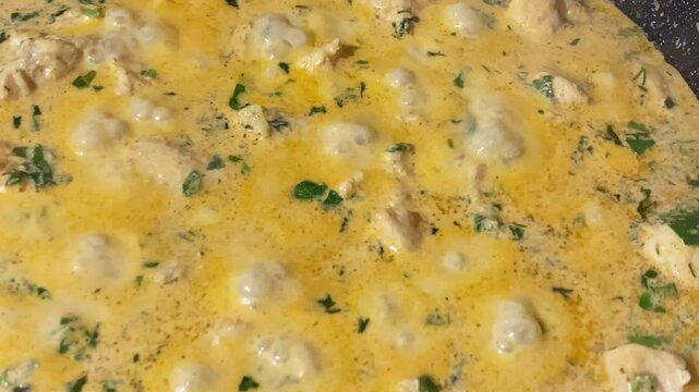 Chkmeruli or Shkmeruli in pan, traditional Georgian dish. Fried chicken is boiling in a milk-garlic sauce.