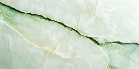 Fototapeta premium The surface of the stone is an uneven light green color with cracks.