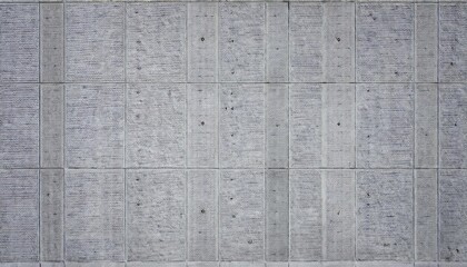gray concrete wall with textured blocks and visible bolts, ideal for industrial and architectural design background