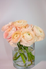 a bouquet of ranunculus flowers in a vase