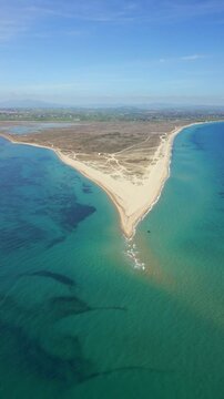 Epanomi Sandbar beach drone aerial view on Tsairi park on the coast of Greece, vertical video