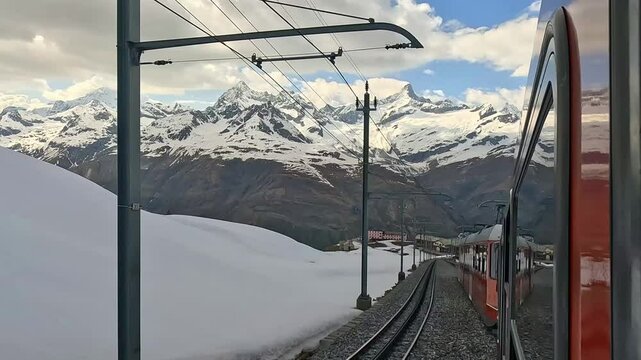 The Gornergrat Bahn train runs downhill towards Zermatt through the Alpine landscape in Zermatt, Switzerland