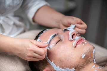 Man enjoying a plant based facial mask treatment at a beauty cen