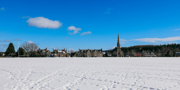 Snow covered landscape in Aberdeen Scotland with historical buildings under a bright blue sky