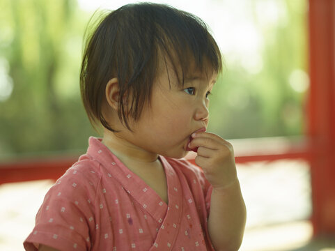 little girl eating strawberry