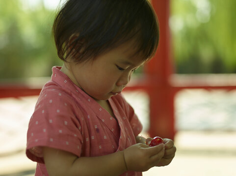 little girl eating strawberry