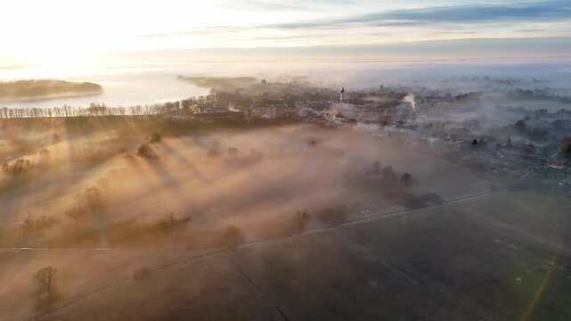 Sunset over a small historic town Trebon. Drone. Fog. Mist.
