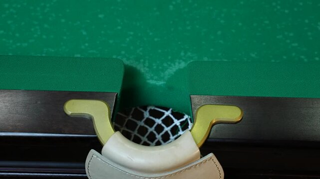 Billiard balls arranged in a manner on a billiard table, smooth movement of the camera on the table.