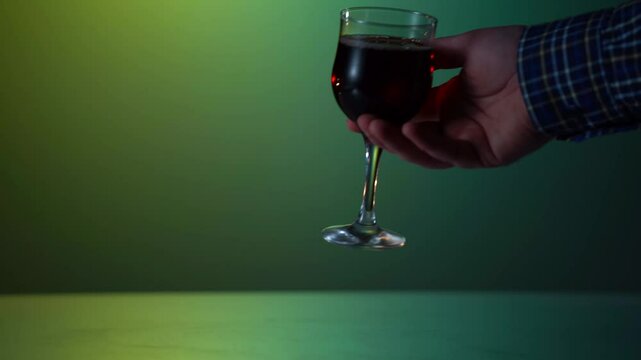 female hands raise wine glass is tied with a jute rope. The concept of alcohol dependence. The problem of alcoholism treatment.