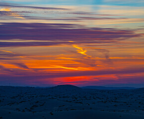 Fototapeta premium Dramatic red morning Sunrise over the desert sand dunes near Abu Dhabi, UAE