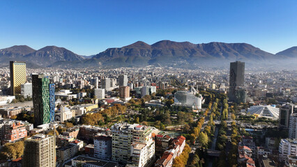 Aerial view of Tirana’s city center on a sunny day, showcasing Skanderbeg Square, modern high-rises, and historic landmarks, with Dajti Mountain in the background. Photo taken 16,11,2024, Tirana, Alba