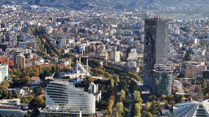 Aerial view of Tirana’s city center on a sunny day, showcasing Skanderbeg Square, modern...