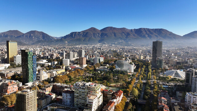 Aerial view of Tirana&rsquo;s city center on a sunny day, showcasing Skanderbeg Square, modern high-rises, and historic landmarks, with Dajti Mountain in the background. Photo taken 16,11,2024, Tirana, Alba