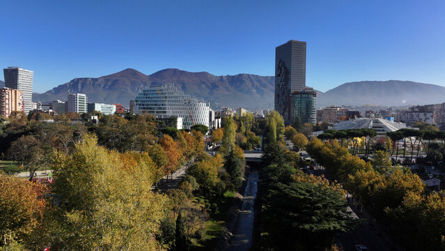 Aerial view of Tirana&rsquo;s city center on a sunny day, showcasing Skanderbeg Square, modern high-rises, and historic landmarks, with Dajti Mountain in the background. Photo taken 16,11,2024, Albania