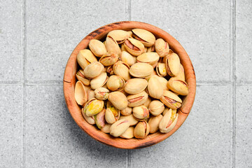 Macro photo. Pistachios in a wooden bowl. Nuts Close-up.