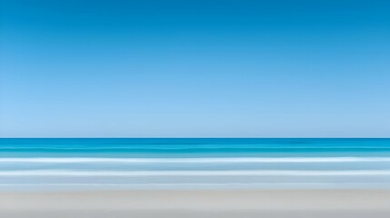 Serene Coastal Landscape: Blue Ocean and Sandy Beach Under a Clear Sky