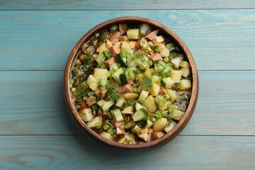 Delicious okroshka soup with kvass on blue wooden table, top view