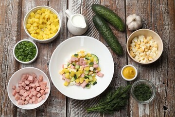 Ingredients for okroshka soup on wooden table, flat lay