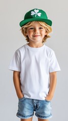 Fototapeta premium Young boy smiling while wearing a green hat and casual outfit, posing with hands in pockets in a bright indoor setting